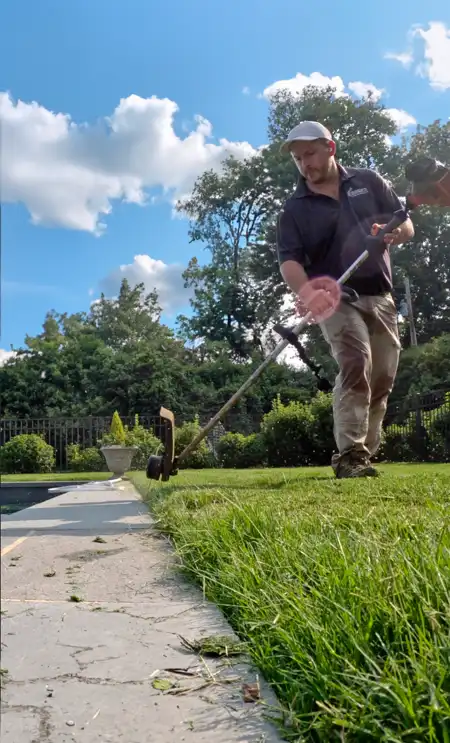 A Barker Brothers landscaper working on lawn care in Charlotte NC