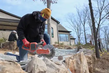 Worker performing hardscaping services in Charlotte, NC.