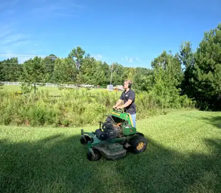 Professional providing lawn mowing service in Charlotte, NC.